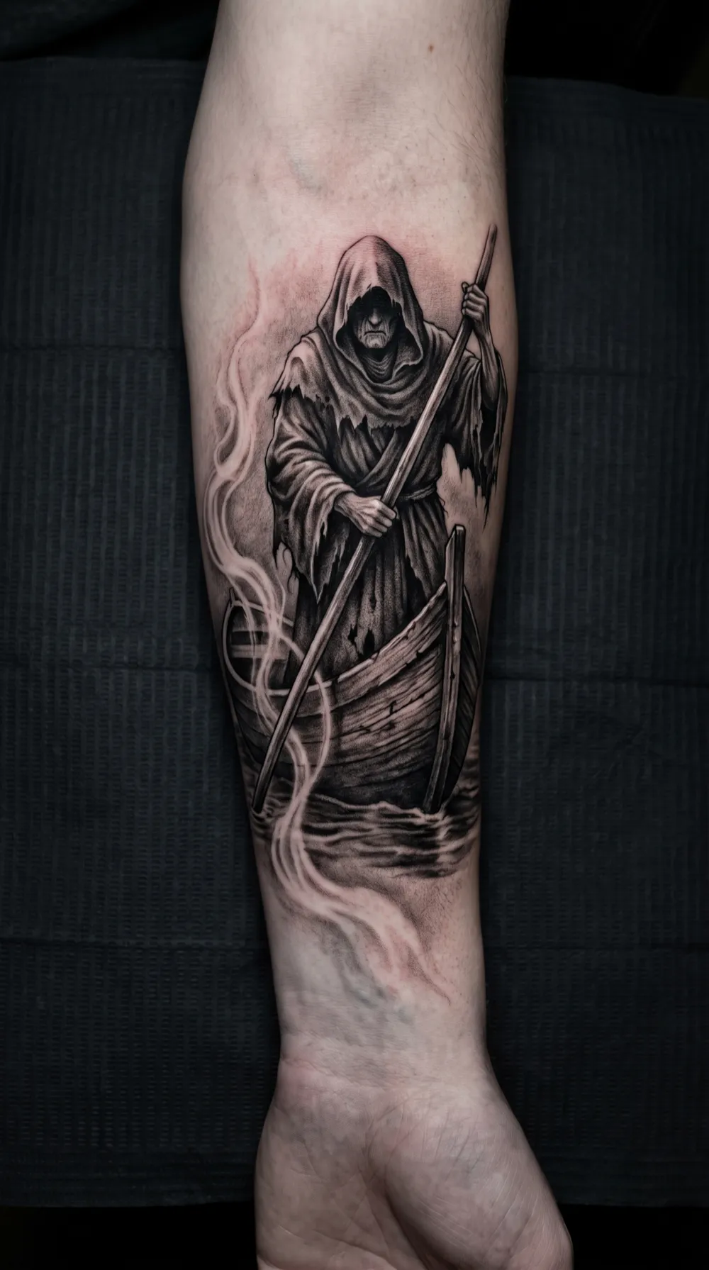 Charon the ferryman crossing dark water on the forearm