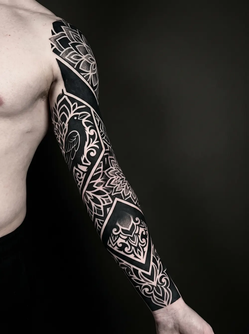 Bold blackwork with negative space on the arm