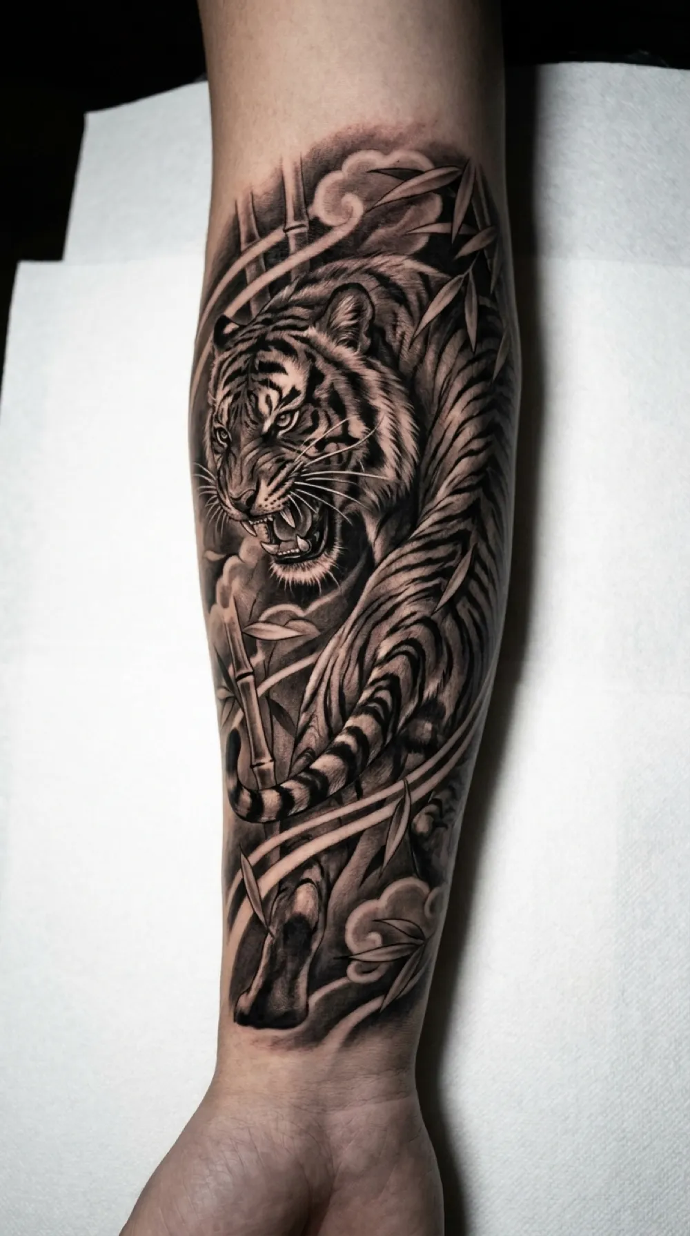 Japanese tiger among bamboo on the forearm